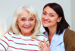 happy caregiver and senior woman