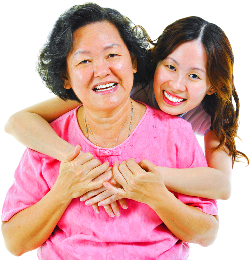 happy caregiver hugging senior woman