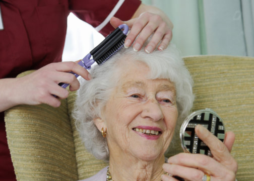 caregiver assisting senior woman indoor